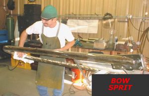 metalsmith working on bow sprit