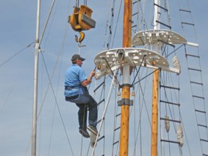 man in harness working on rigging